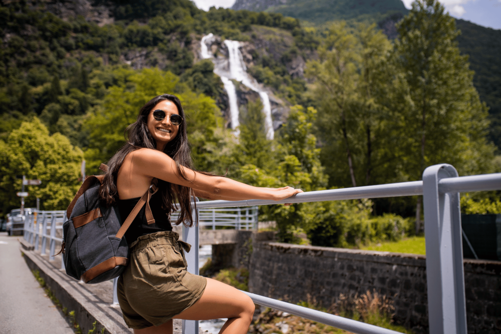 Solo female travel - safest countries in the world. backpacking woman near a waterfall. Tengah