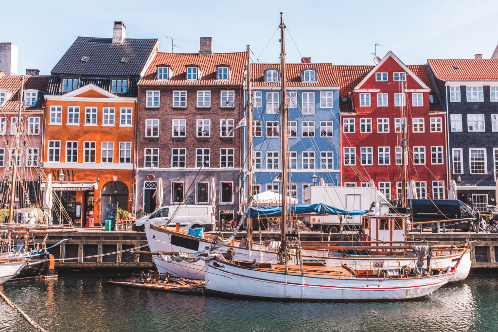 A row of houses in Denmark. Denmark is one of the safest countries for solo female travel. Download Tengah to help you travel.