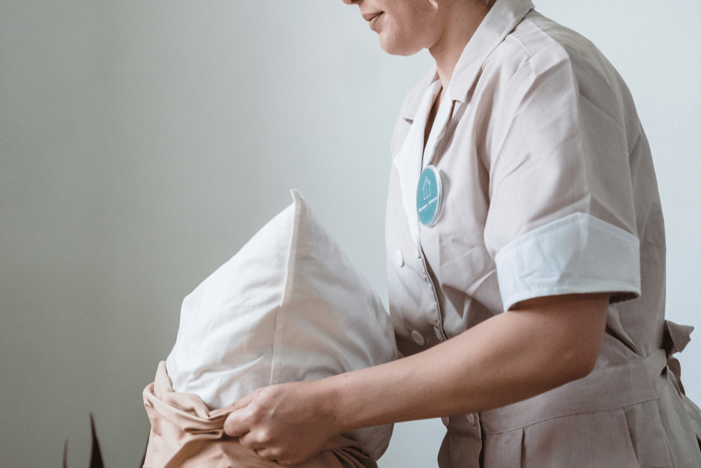 A housekeeper changing pillow case at a luxury hotel. Tips and tricks to get upgraded. 